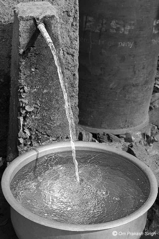 Valuable clean drinking water gushing out of a ‘tap-less’ FHTC in a rural household in Seraikela-Kharsawan district, Jharkhand, India
